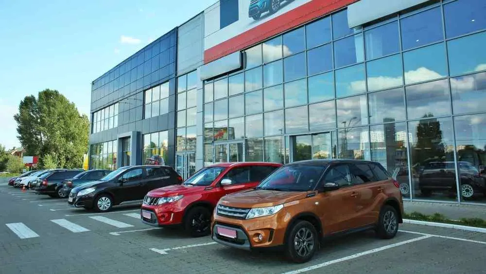 Cars parked outside a dealership showroom