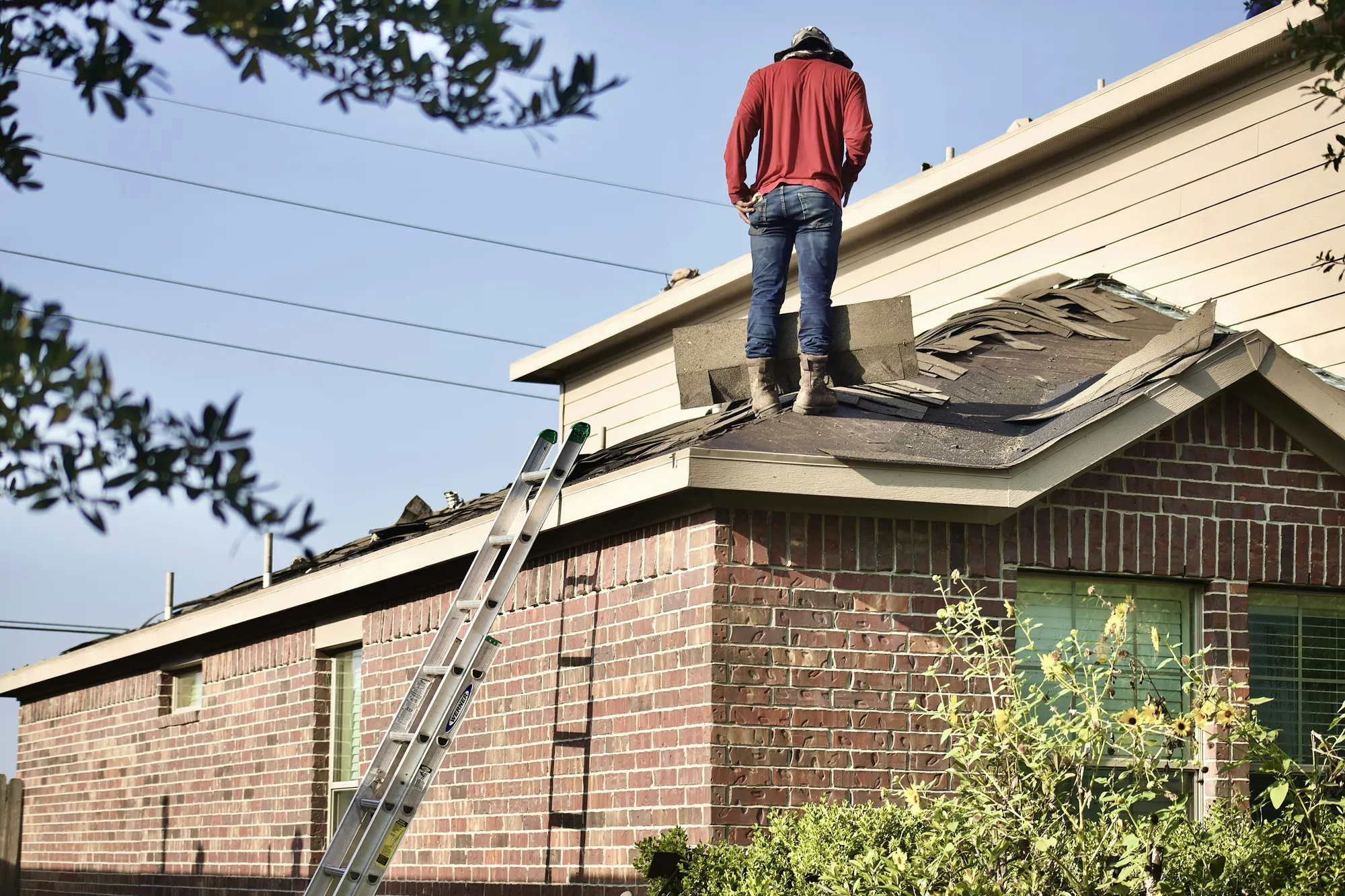 a person on a ladder on a roof
