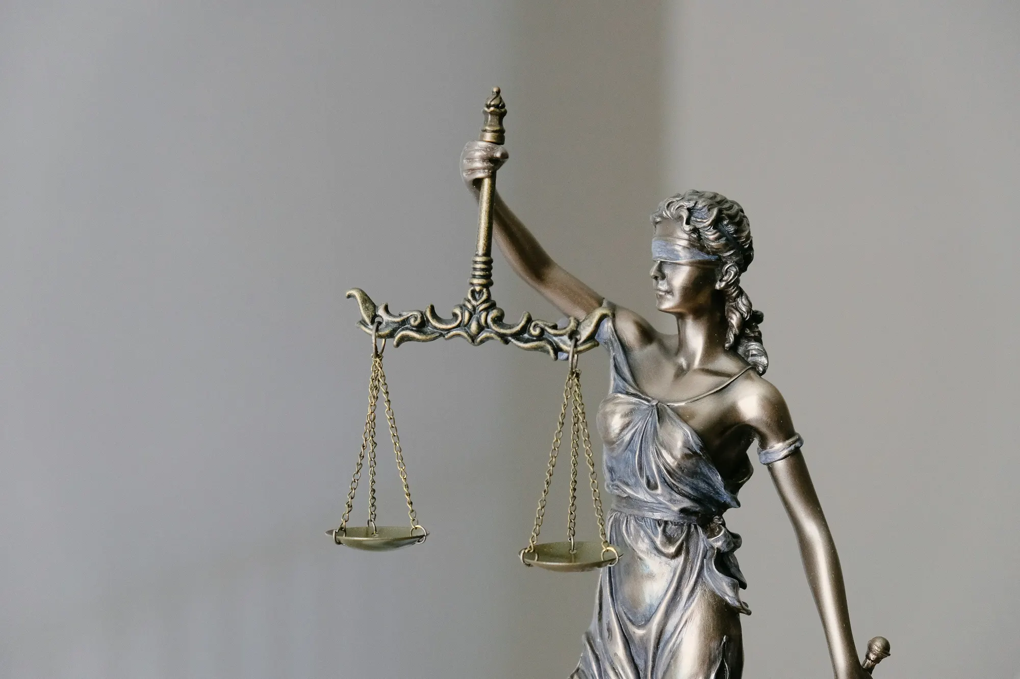 a statue of a person holding a staff